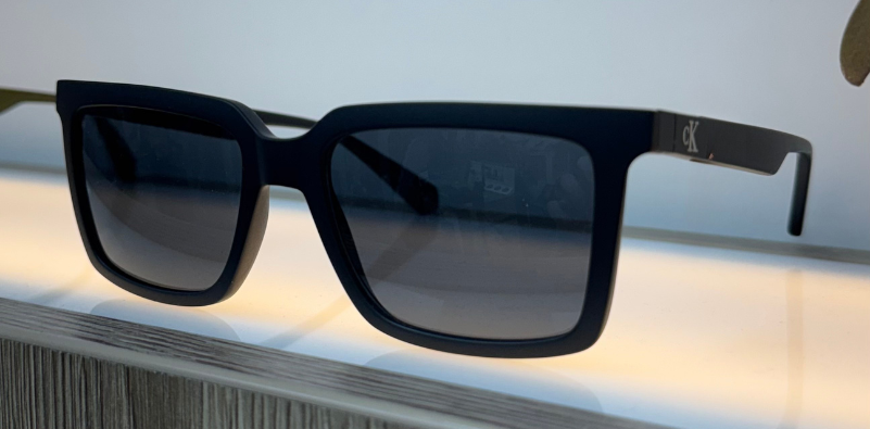A pair of black, rectangular Calvin Klein sunglasses